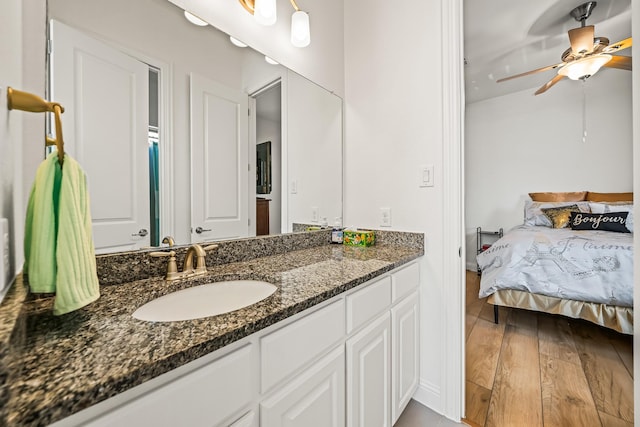 bathroom with vanity, hardwood / wood-style floors, and ceiling fan