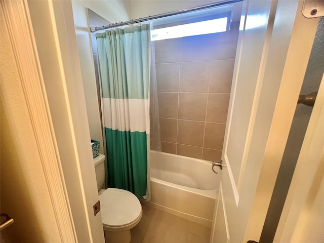 bathroom featuring toilet, tile patterned flooring, and shower / bathtub combination with curtain