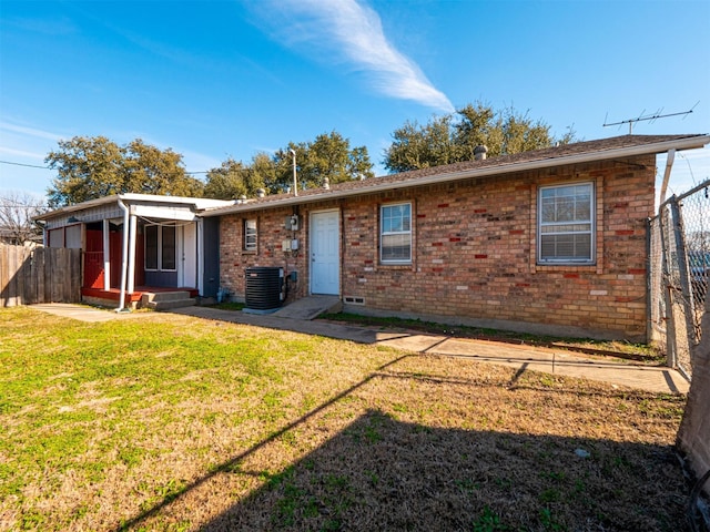 exterior space with a lawn and central AC unit