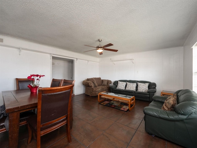 living room featuring a textured ceiling and ceiling fan