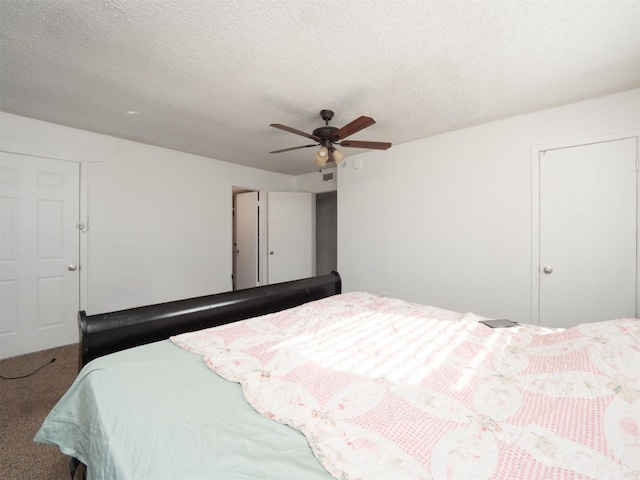 carpeted bedroom with a textured ceiling and ceiling fan