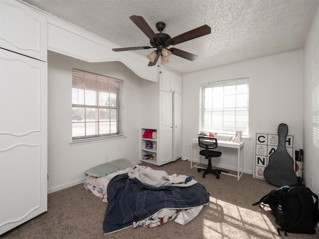 bedroom with ceiling fan, a textured ceiling, vaulted ceiling, and dark colored carpet