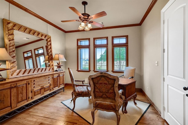 living area with ceiling fan, ornamental molding, and light hardwood / wood-style flooring