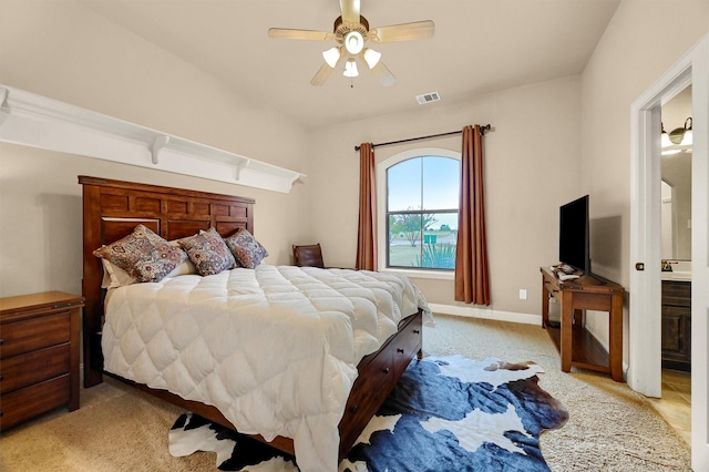 carpeted bedroom featuring ceiling fan and connected bathroom