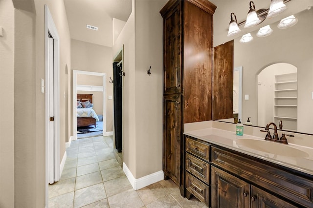 bathroom with tile patterned flooring and vanity