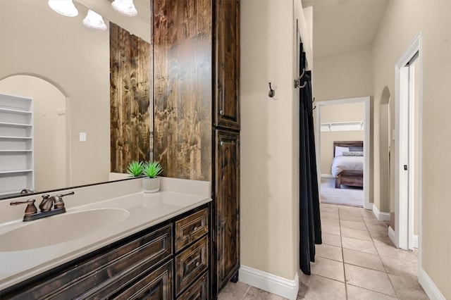 bathroom with tile patterned floors and vanity