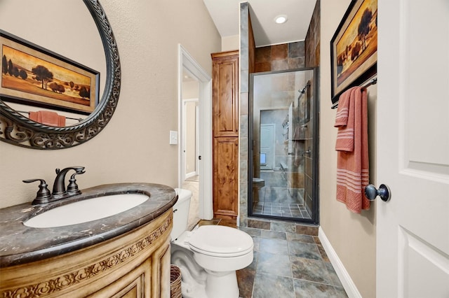 bathroom with toilet, a shower with door, and vanity