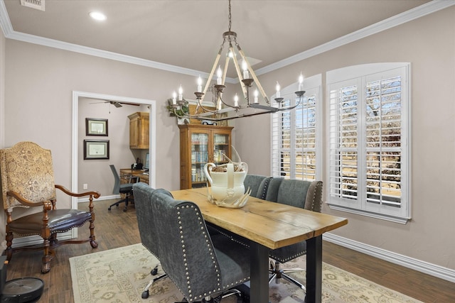 dining space with ornamental molding, ceiling fan with notable chandelier, and dark hardwood / wood-style floors