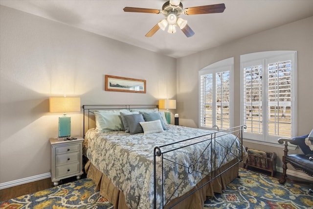 bedroom with ceiling fan and dark hardwood / wood-style floors