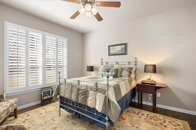 bedroom with dark wood-type flooring and ceiling fan