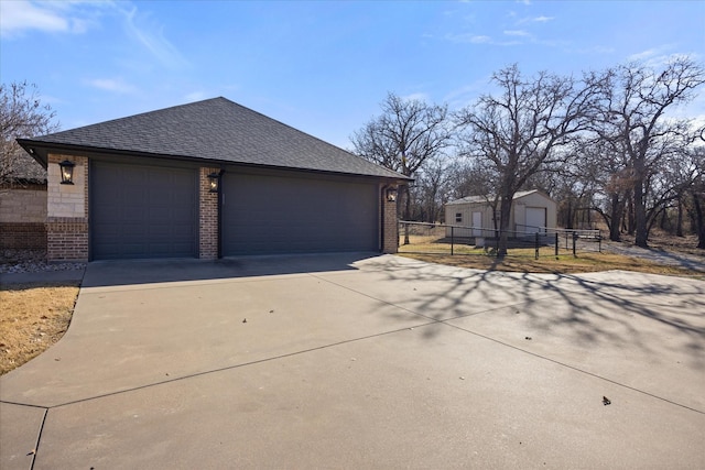 view of side of property featuring a garage and an outbuilding