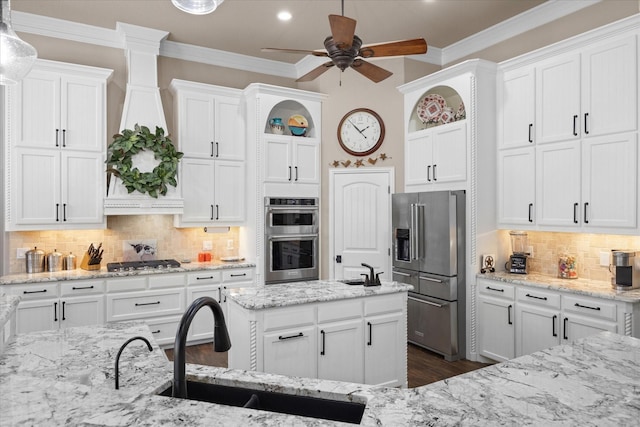 kitchen featuring sink, hanging light fixtures, appliances with stainless steel finishes, and tasteful backsplash