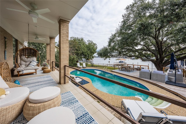 view of pool with ceiling fan, outdoor lounge area, and a patio