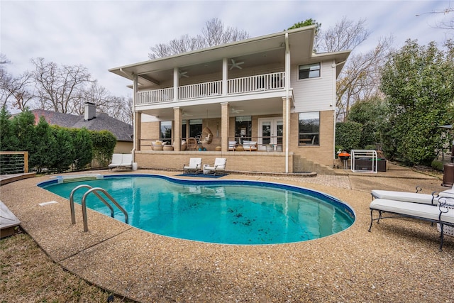 view of pool with ceiling fan, french doors, and a patio