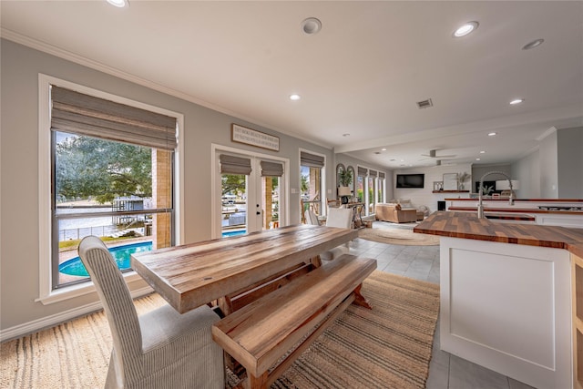 dining space featuring ornamental molding and french doors