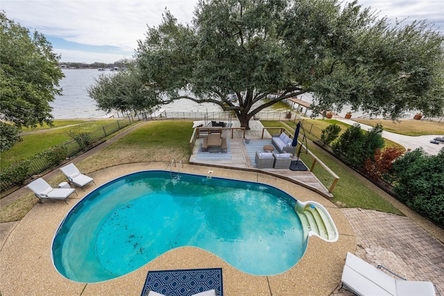 view of pool with a patio area, a water view, outdoor lounge area, and a lawn