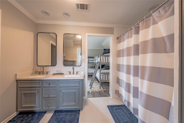 bathroom featuring ornamental molding, tile patterned floors, and vanity