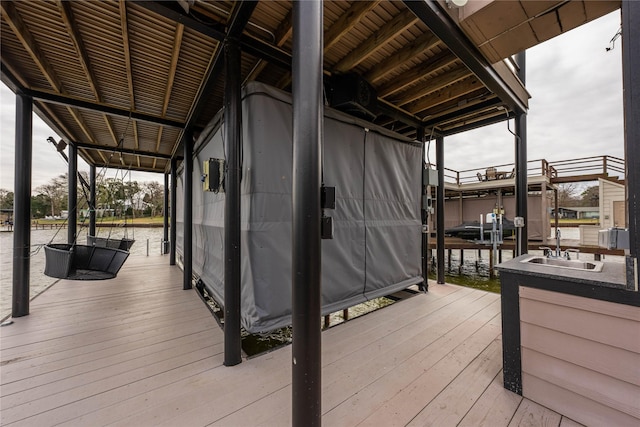 wooden terrace featuring sink and a dock