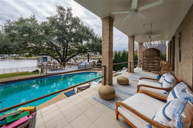 view of swimming pool featuring a water view, an outdoor hangout area, ceiling fan, and a patio