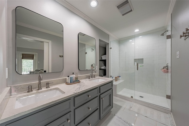 bathroom with an enclosed shower, vanity, tile patterned flooring, and crown molding