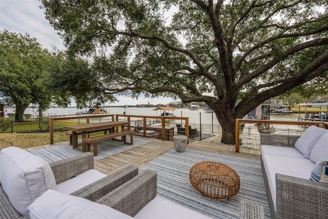 deck with an outdoor hangout area and a water view