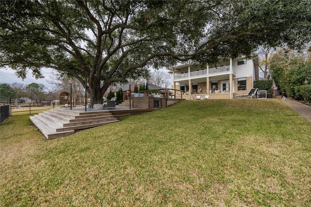 view of yard with a balcony