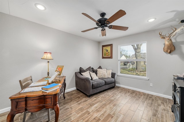 living area with ceiling fan and light hardwood / wood-style flooring