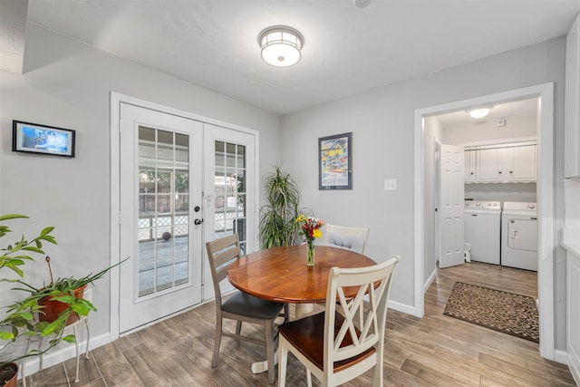 dining room with french doors, plenty of natural light, independent washer and dryer, and light hardwood / wood-style flooring