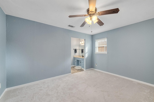 empty room with ceiling fan and light colored carpet