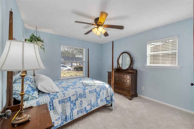 carpeted bedroom with ceiling fan and multiple windows