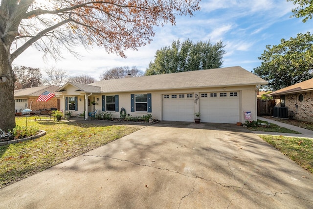 ranch-style home with central air condition unit, a front lawn, and a garage