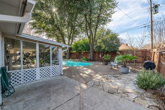 view of patio / terrace with a fenced in pool and a sunroom