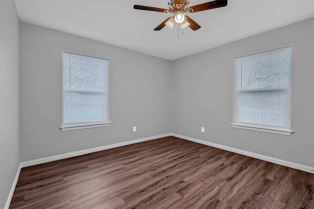 spare room featuring ceiling fan, a wealth of natural light, and hardwood / wood-style flooring