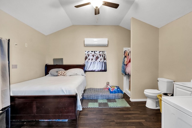 bedroom with a wall mounted AC, ceiling fan, dark hardwood / wood-style floors, lofted ceiling, and washer / clothes dryer