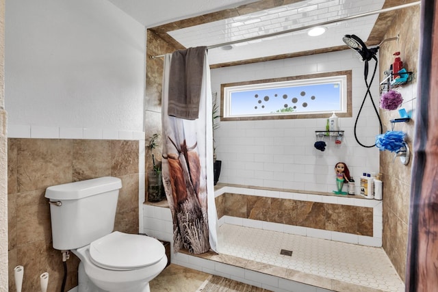 bathroom with toilet and a shower with shower curtain