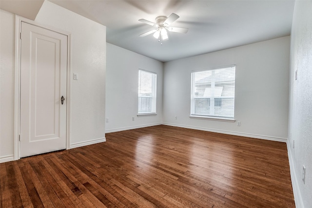 unfurnished room with ceiling fan and dark hardwood / wood-style floors