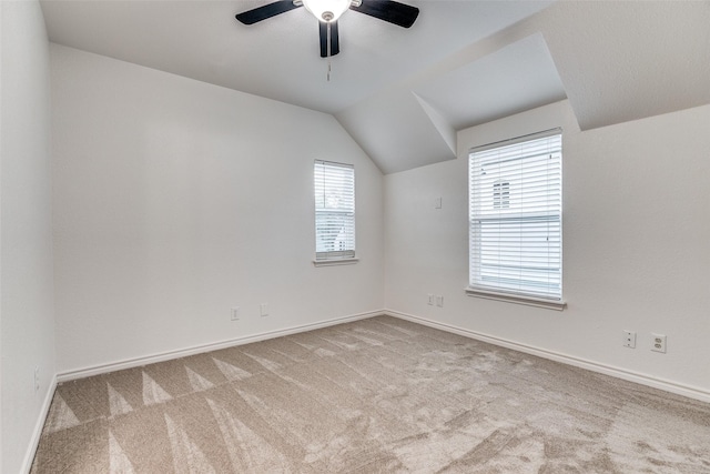 additional living space with ceiling fan, lofted ceiling, and light colored carpet