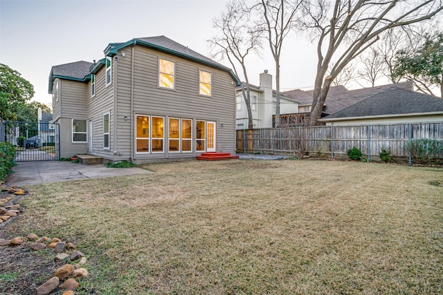 back of property with a patio area and a yard