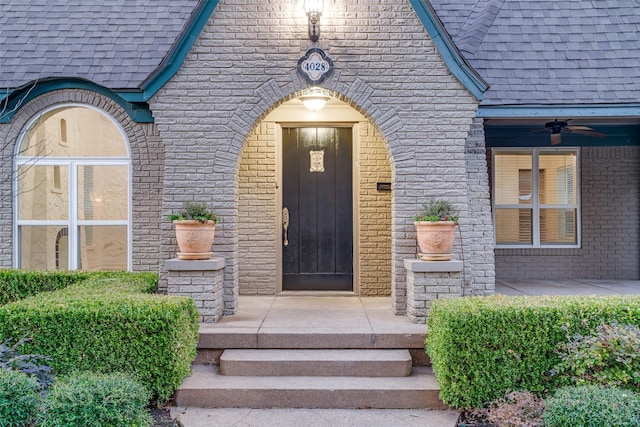 view of exterior entry with ceiling fan