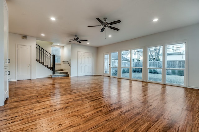 unfurnished living room featuring ceiling fan and light hardwood / wood-style flooring