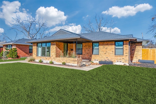 rear view of property featuring a lawn