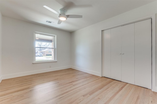 unfurnished bedroom with ceiling fan, a closet, and light hardwood / wood-style flooring