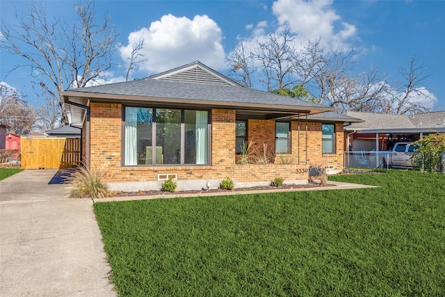 rear view of house featuring a lawn