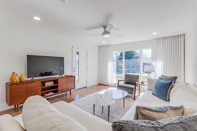 living room featuring ceiling fan and light hardwood / wood-style floors