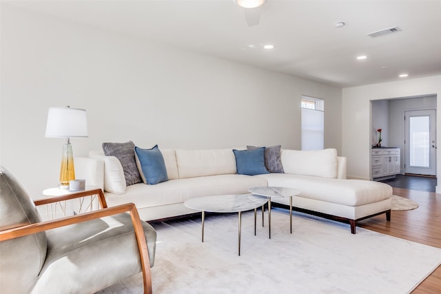 living room featuring hardwood / wood-style flooring and ceiling fan