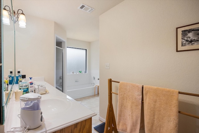 bathroom featuring tile patterned flooring, shower with separate bathtub, a chandelier, and vanity