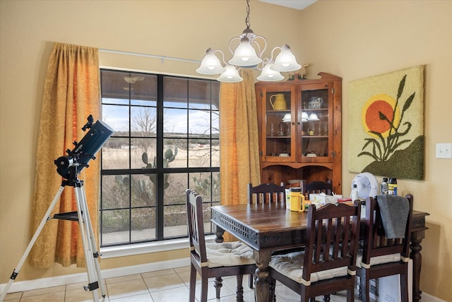 tiled dining area with a chandelier