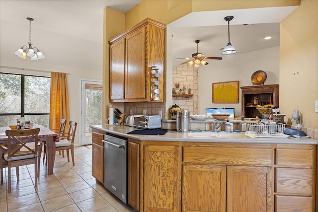 kitchen with kitchen peninsula, dishwasher, tasteful backsplash, and decorative light fixtures