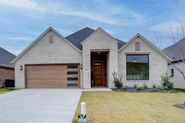 view of front of property featuring central air condition unit, a garage, and a front yard