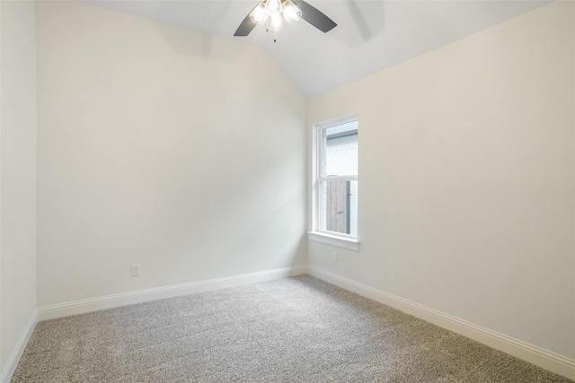 empty room with lofted ceiling, ceiling fan, and carpet